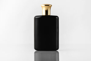 front view black fragrance designed with gold cap white floor